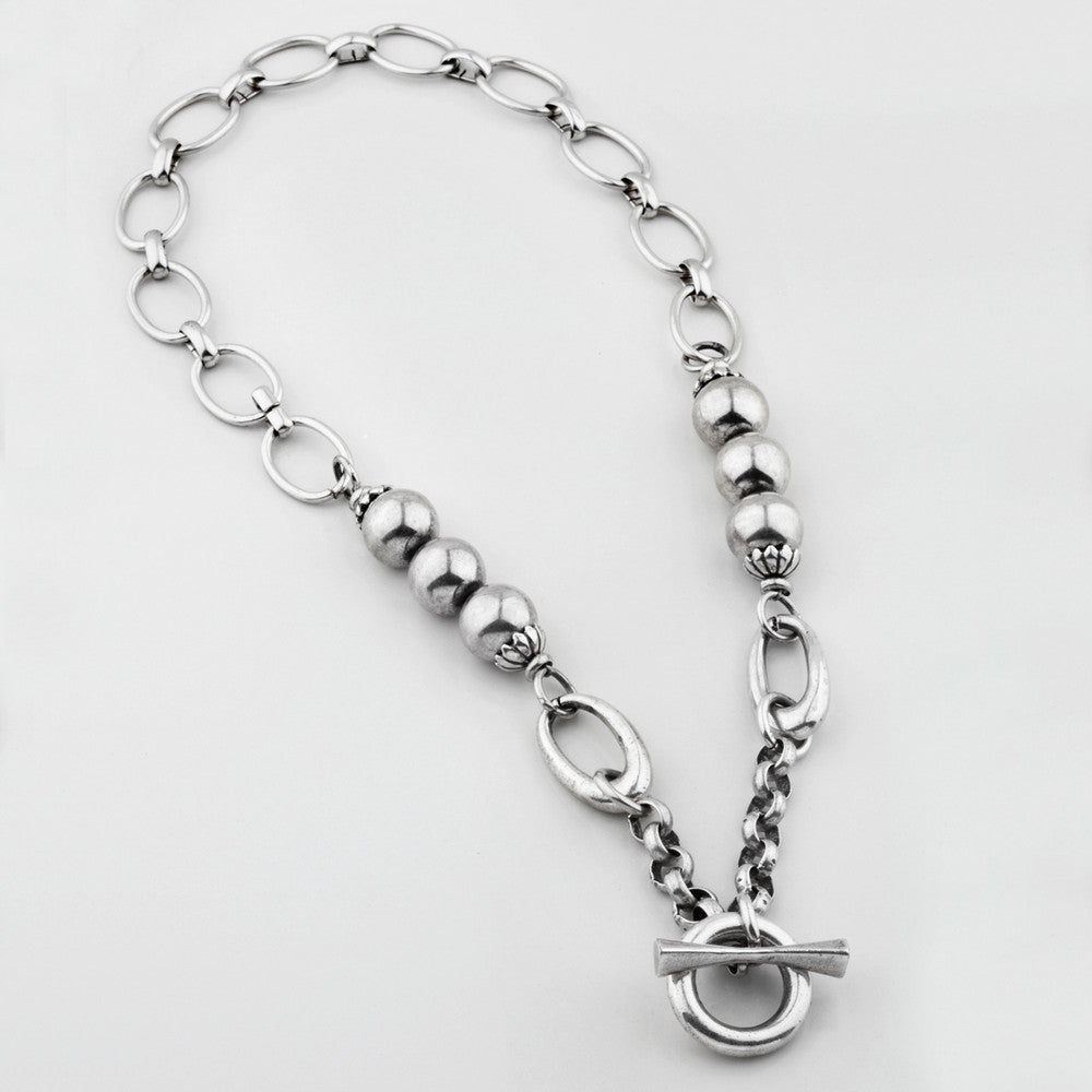 Contemporary mixed chain necklace in burnished silver with smooth silver beads. Finished with T-bar and fob closure