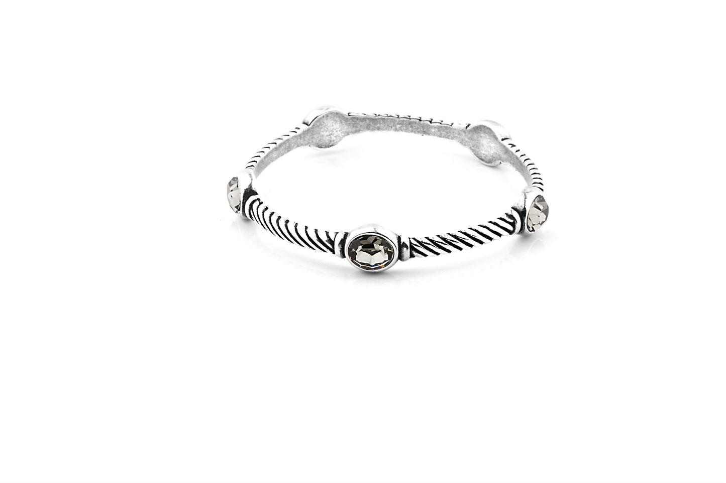 A sterling silver bangle bracelet featuring textured twisted rope detailing, five oval bezel-set black diamond crystals on a white background.