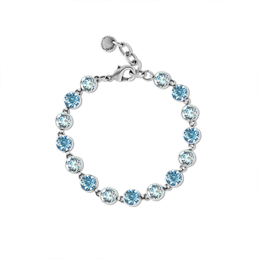 Silver bracelet with blue gemstones on a white background
