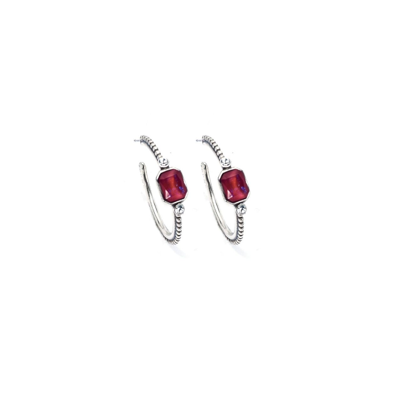 Pair of hoop earrings with red gemstones on a white background
