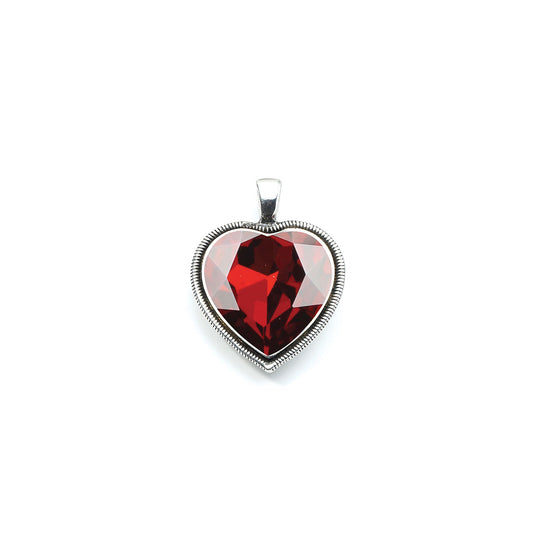 Heart-shaped pendant with a red gemstone on a white background