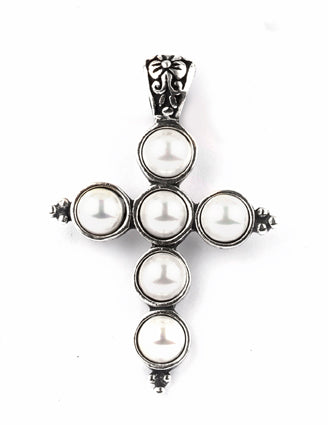 Cross-shaped pendant with pearl-like stones on a white background