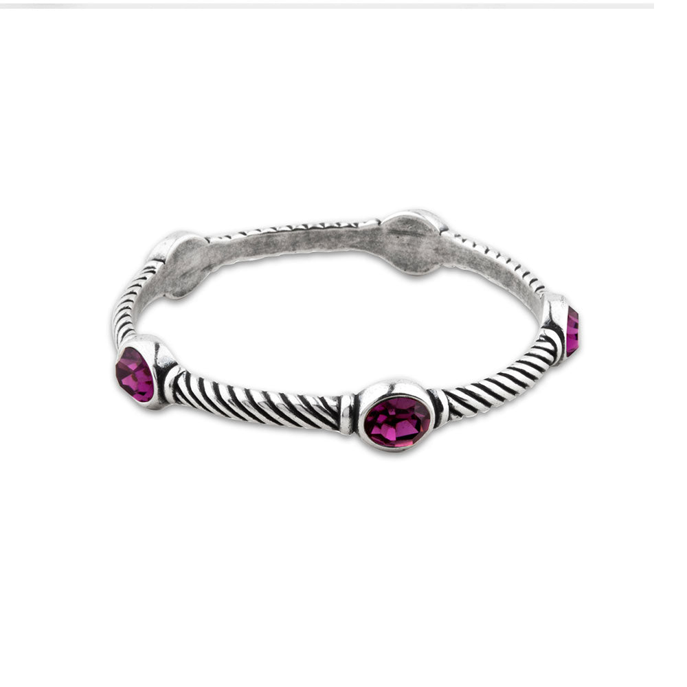 A burnished silver twisted bangle bracelet featuring five oval amethyst gemstones, set against a plain white background.