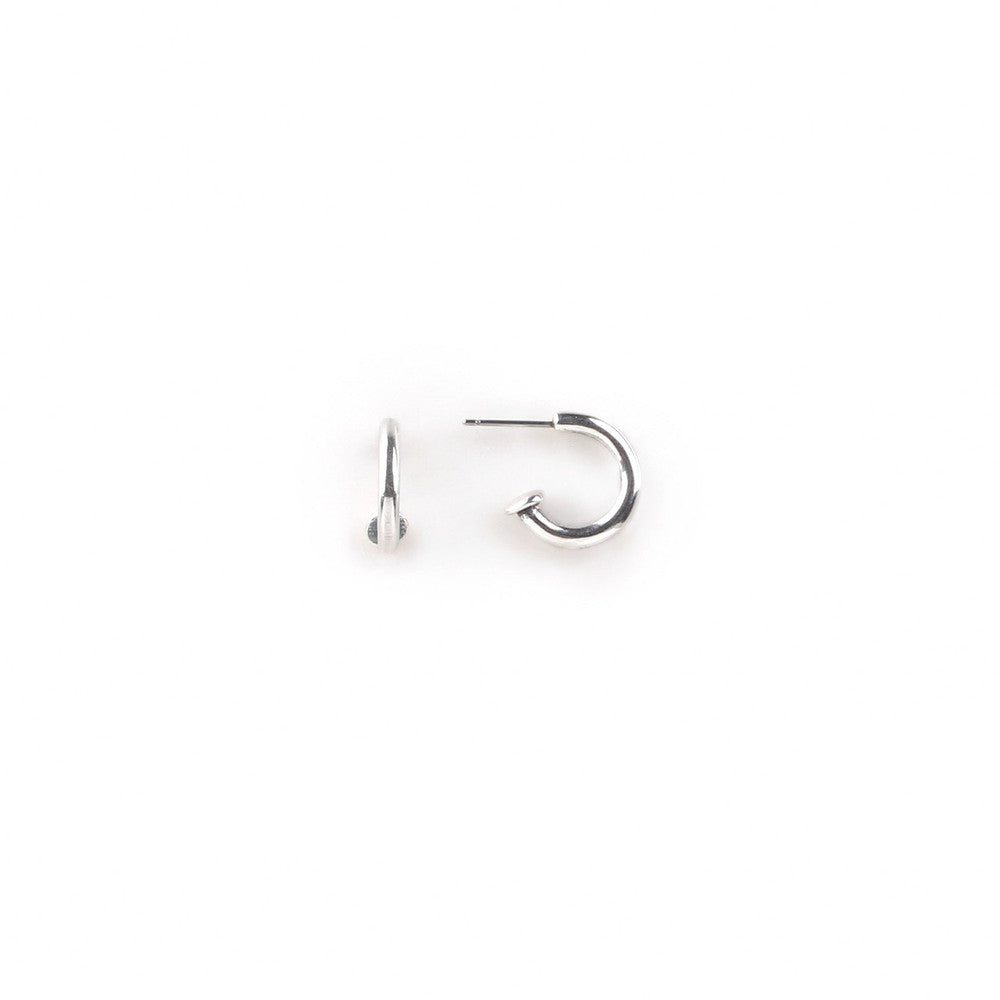 A pair of small, round, silver hoop earrings on a white background