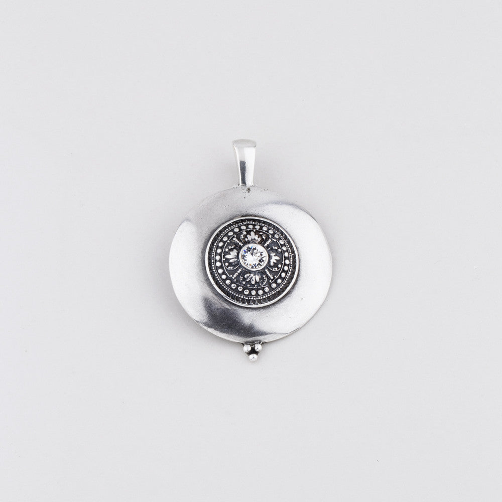 Burnished silver plated disc pendant with a detailed centre embellished with a Swarovski® Crystal 