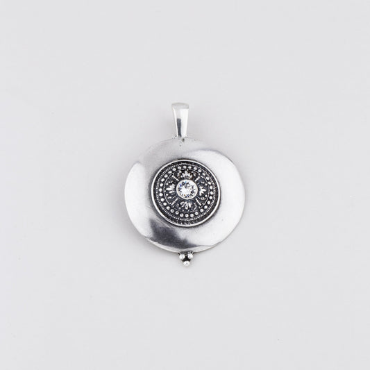 Burnished silver plated disc pendant with a detailed centre embellished with a Swarovski® Crystal 